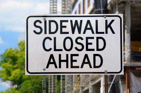 Sidewalk Closed Ahead sign near a construction siteの写真素材
