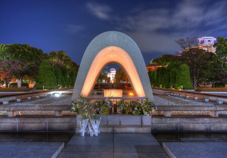 Cenotaph through which the Atomic Dome can be seen at at Peace Memorial Park in Hiroshima, Japan.のeditorial素材