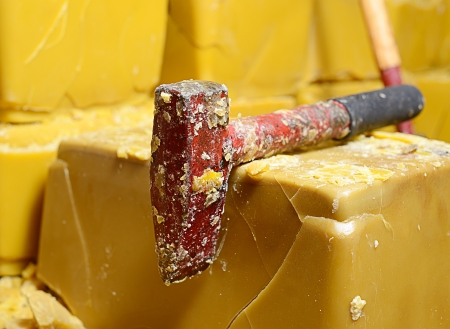 blocks of honey bee's wax and cutting toolsの写真素材