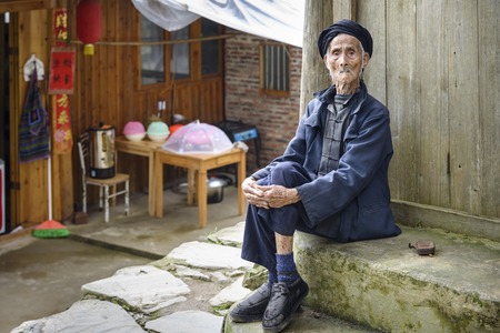 An elderly member of the Yao minority people in Tiantou Village, Guangxi, China.のeditorial素材