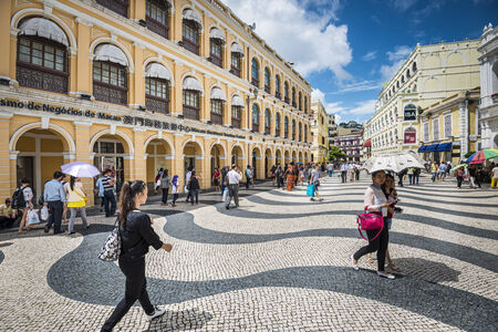 MACAU, CHINA - MAY 21, 2014: Pedestrians stroll down Senado Square. The territory was the last European colony in Asia and the architecture is inspired by the former Portuguese rule.のeditorial素材