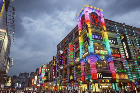GUANGZHOU, CHINA - MAY 25, 2014: Pedestrians pass through Shangxiajiu Pedestrian Street. The street is the main shopping district of the city and a major tourist attraction.のeditorial素材