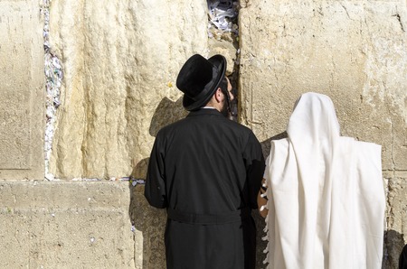 JERUSALEM, ISRAEL - FEBRUARY 19, 2012: Worshipers pray at the western wall. The wall is the most sacred site in Judaism outside of the Temple Mount itself.のeditorial素材
