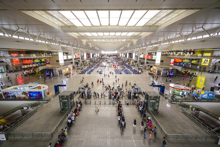 SHANGHAI, CHINA - JUNE 23, 2014: Passengers wait for trains in Shanghai Hongqiao Railway Station. It is the largest railway station in Asia with an area of 1.3 million square meters.のeditorial素材