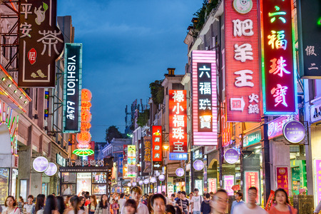 GUANGZHOU, CHINA - MAY 25, 2014: Pedestrians pass through Shangxiajiu Pedestrian Street. The street is the main shopping district of the city and a major tourist attraction.のeditorial素材