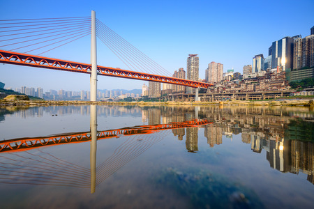 Chongqing, China cityscape at the Jialing River and Qianximen Bridge.の写真素材