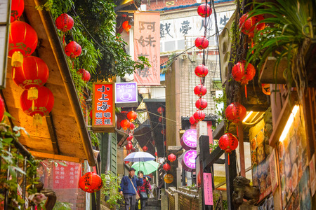JIUFEN, TAIWAN - JANUARY 17, 2013: Tourists stroll through quaint alleys of Jiufen. The town is a tourist attraction renown for a its unique atmosphere.のeditorial素材
