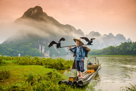 A traditional cormorant fisherman works on the Li River Yangshuo, China.のeditorial素材