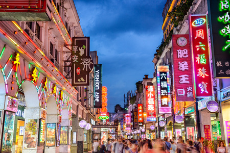 GUANGZHOU, CHINA - MAY 25, 2014: Pedestrians pass through Shangxiajiu Pedestrian Street. The street...