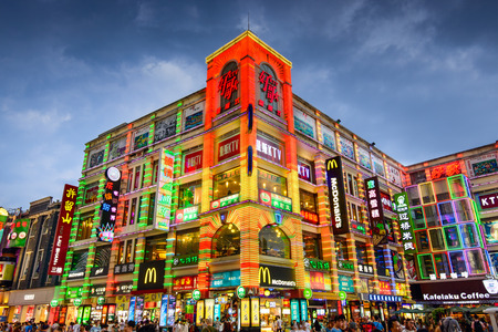 GUANGZHOU, CHINA - MAY 25, 2014: Pedestrians pass through Shangxiajiu Pedestrian Street. The street is the main shopping district of the city.のeditorial素材