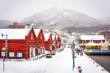 HAKODATE, JAPAN - FEBRUARY 2, 2017: Tourists enjoy a snowy day at historic Kanemori warehouse district. Hakodate Port was among the first Japanese ports to be opened to international trade.のeditorial素材