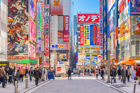 TOKYO, JAPAN - JANUARY 11, 2017: Crowds pass below colorful signs in Akihabara. The historic district electronics has evolved into the shopping area for video games, anime, manga, and computer goods.のeditorial素材