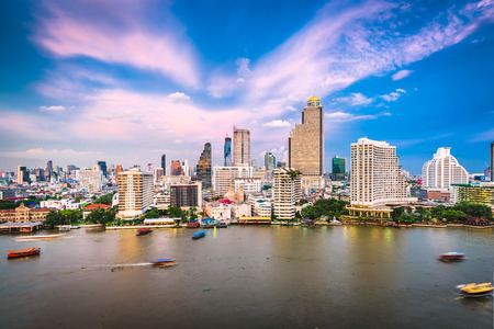 Bangkok, Thailand cityscape on the river at dusk.