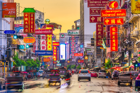 BANGKOK, THAILAND - SEPTEMBER 27, 2015: Traffic on Yaowarat Road passes below lit signs in the Chinatown district at dusk.のeditorial素材