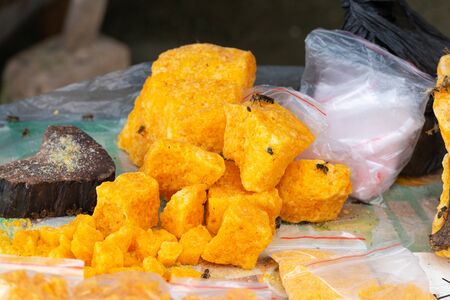 Raw honey on display attracting bees on a farm in Guilin, China.の写真素材