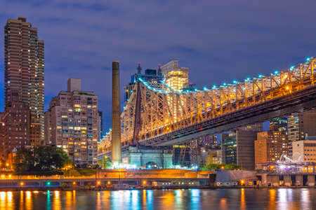 New York City midtown Manhattan cityscape on the East River at twilight.のeditorial素材