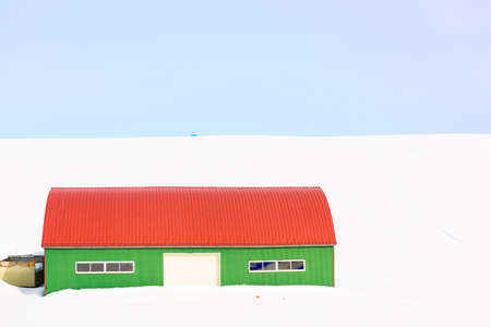 Wintery countryside and barnhouse in Biei, Japan.