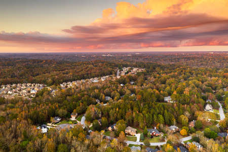 Suburban neighborhoods viewed from above during an autumn dusk.