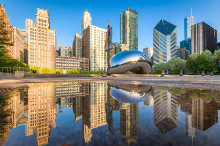 CHICAGO - ILLINOIS: MAY 9, 2018: Cloud Gate in Millennium Park reflected in a rain puddle with clear skies.のeditorial素材