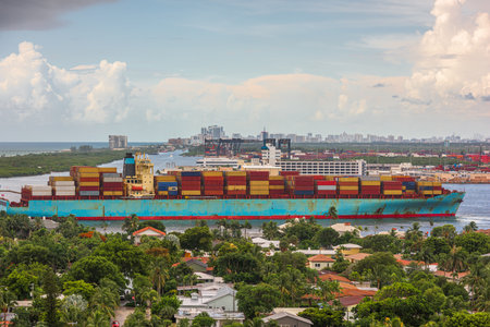 A cargo ship passes through the rivers of Ft. Lauderdale, Florida, USA.の写真素材