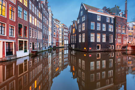 Amsterdam, Netherlands with narrow canals and buildings lining them in the morning time.の写真素材