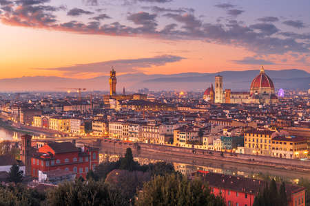 Florence, Italy skyline with landmark buildings at dusk over the Arno River.の写真素材