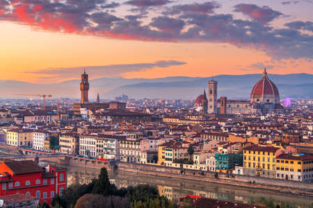 Florence, Italy skyline with landmark buildings at dusk over the Arno River.の写真素材