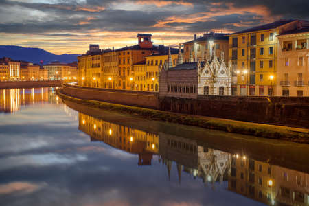 Pisa, Italy skyline on the Arno River with Chiesa di Santa Maria della Spina at dusk.の写真素材