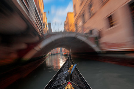 Moving down a canal on a gondola in Venice, Italy.の写真素材
