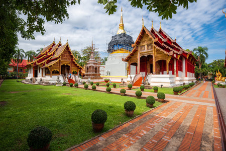 CHIANG MAI, THAILAND - OCTOBER 14, 2015: Visitors exit a hall at Wat Phra Singh in Chiang Mai, Thailand.のeditorial素材