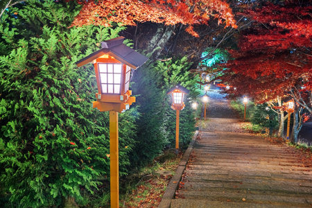 Fujiyoshida, Japan lanterns lead from Arakura Sengen Shrine  at dusk during autumn season.の写真素材