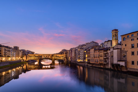 Florence, Italy at the Ponte Vecchio Bridge crossing the Arno River at twilight.の写真素材