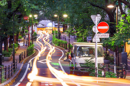 Shibuya, Tokyo, Japan street scene and windy road under a canopy of greenery.の写真素材
