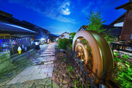 Magome, Japan along the Nakasendo with a waterwheel at night.の写真素材