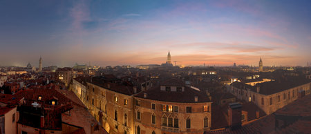 Venice, Italy rooftop skyline and historic landmarks at dusk.の写真素材