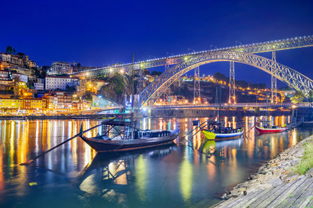 Porto, Portugal old town skyline on the Douro River with rabelo boats at night.の写真素材