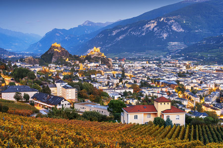 Sion, Switzerland in the Canton of Valais at blue hour over vineyards in autumn.の写真素材
