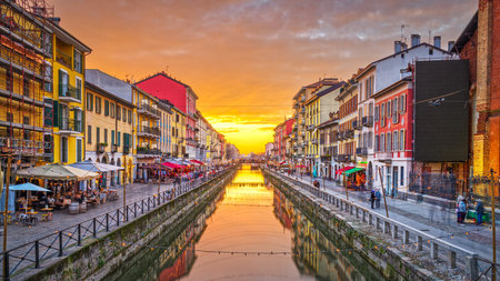 Naviglio Canal, Milan, Lombardy, Italy with a dramatic golden hour sky.の写真素材