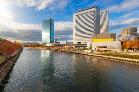 Osaka, Japan cityscape reflections in the moat during autumn season.の写真素材