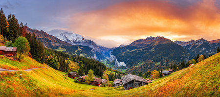 Lauterbrunnen, Switzerland valley from Wengen in the fall season with colorful foliage at dusk.の写真素材