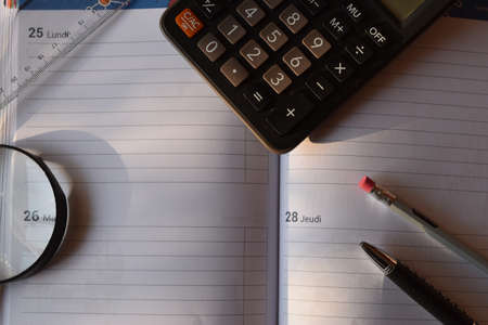 Office supplies on a blank agenda in french with empty space