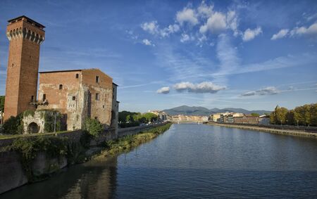 The citadel of Pisa from a bridge over Arno riverの写真素材