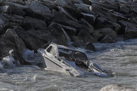 Sinking boat in front of the port of Riminiの写真素材