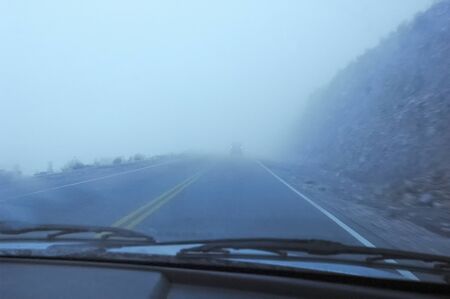 Foggy road view from inside a carの写真素材