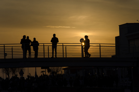 View of an orange sunset over pedestrian bridgeの写真素材