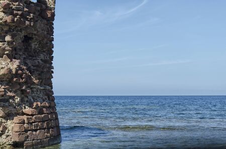 Ruin of tower emerges from the seaの写真素材