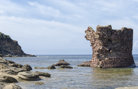 Ancient ruin of tower emerges from the seaの写真素材
