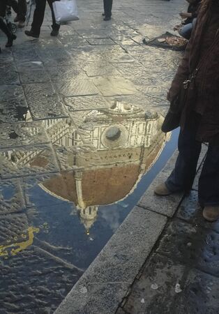 Reflection of Brunelleschi dome in a puddleの写真素材