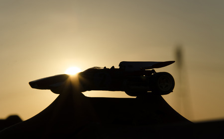 Shape of beautiful racing car with sunset in backgroundの写真素材