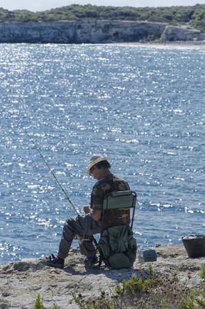 Torre dell'Orso, Italy - September 22, 2017: Solitary old fisherman on the Salento cliffのeditorial素材